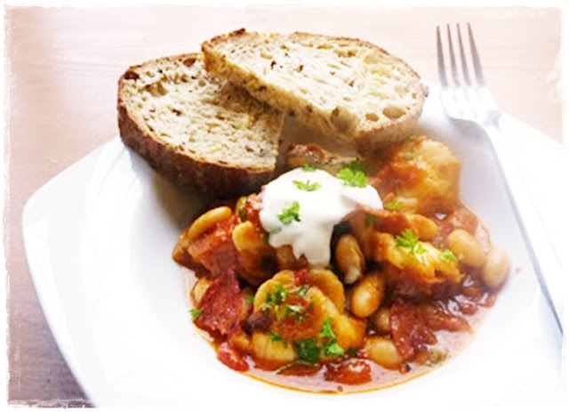 white fish with beans and chorizo in a tomato sauce